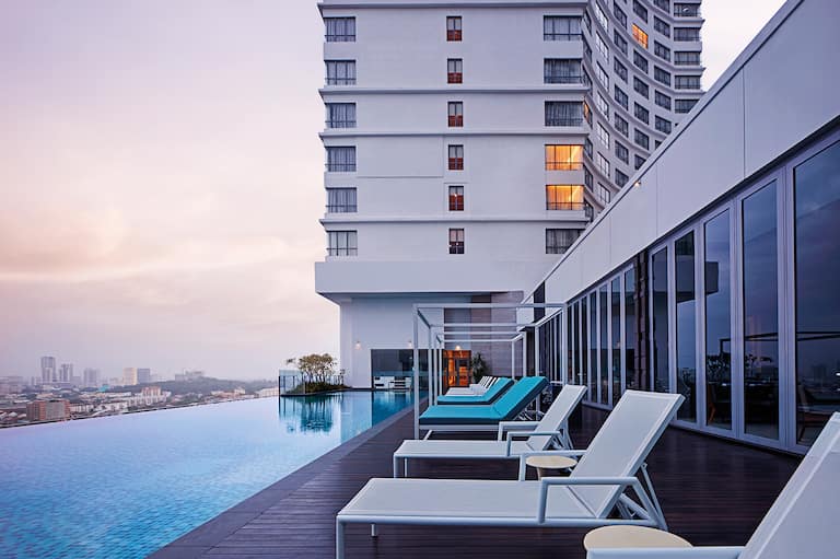 rooftop outdoor pool and lounge area at dusk