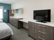 HDTV and Furnishings in Guest Room with Two Beds