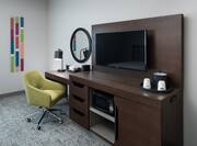 Work Desk with Mirror Microwave and HDTV in Hotel Guest Room