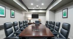 Boardroom with Large Meeting Table, Office Chairs and Wall Mounted HDTV