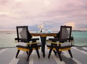 Table and chairs with sea view