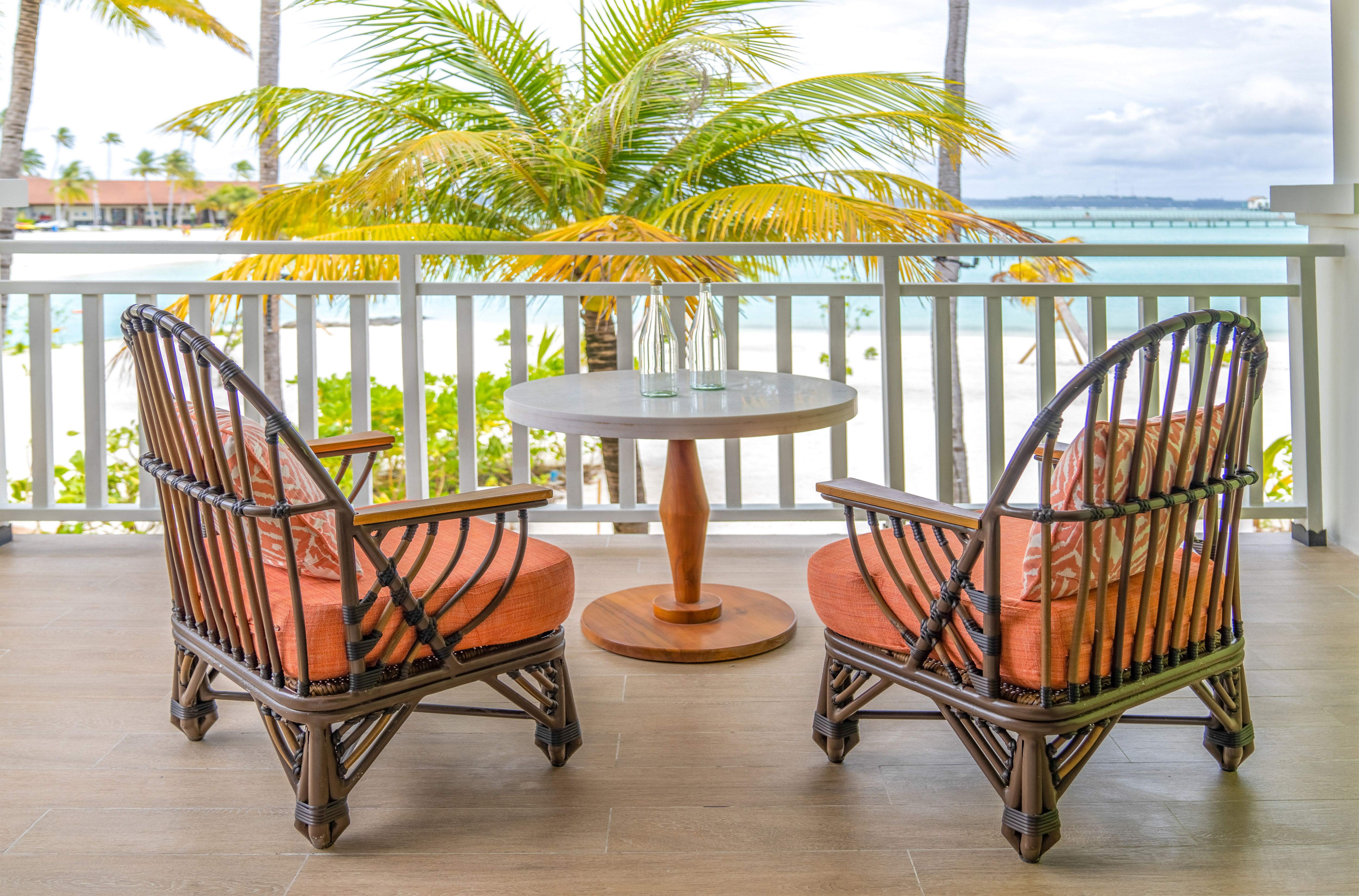 Guest Room Terrace with Small Round Table Two Chairs and Beach View
