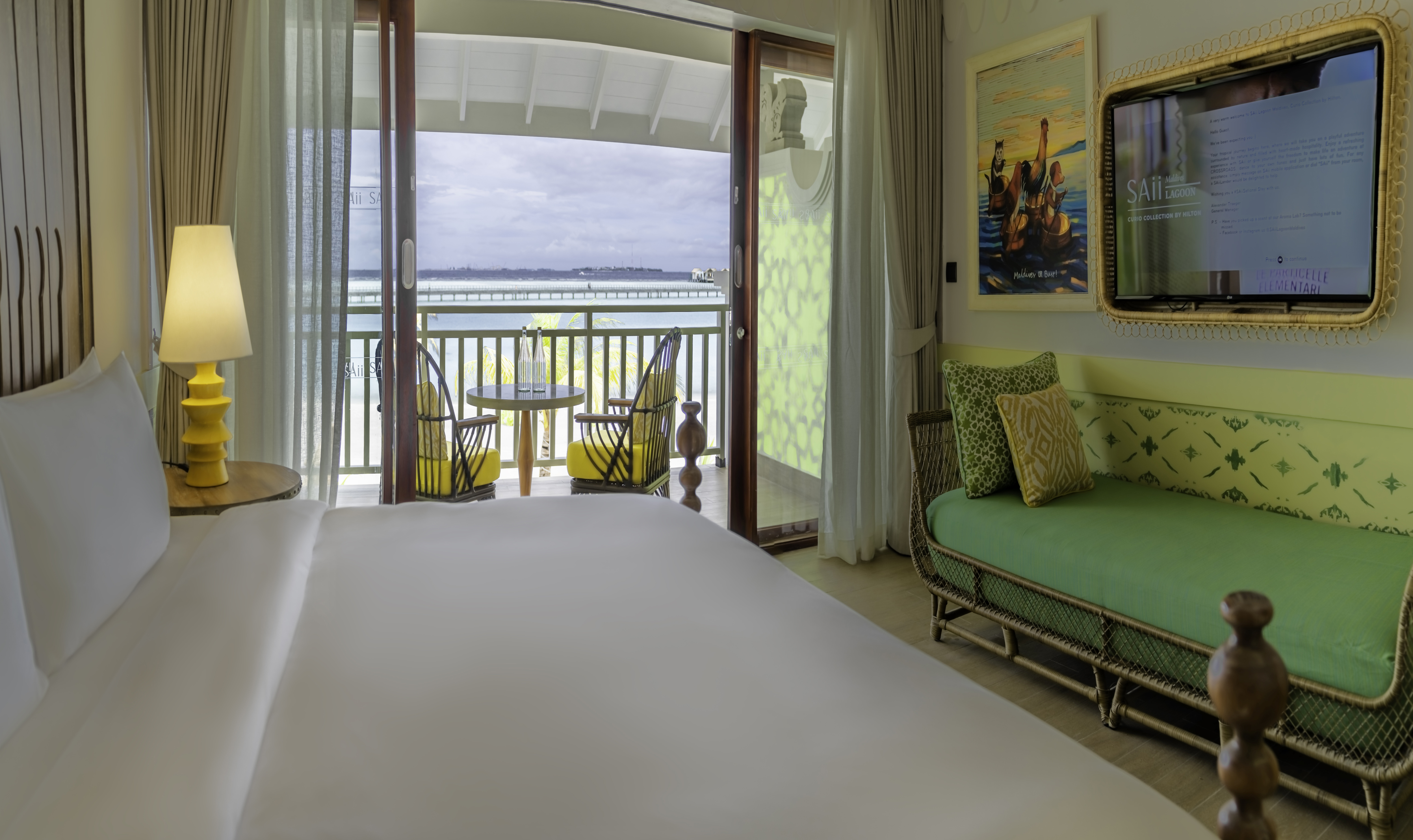 Bed and Living Area in a Guest Room with Ocean View from Balcony