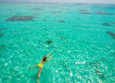 Girl Swimming In Ocean