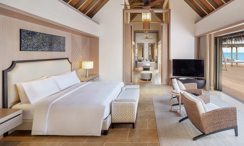 King Grand Reef Villa Bedroom with Lounge Area, Room Technology, and Outside View-previous-transition