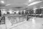 Indoor pool with seating around the edges.