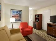 Guest Suite Lounge Area with Armchair, Footrest, Sofa, HDTV and Beverage Station