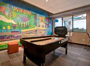 lobby area with mural and shuffleboard 