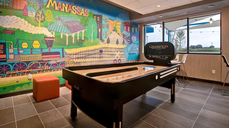 lobby area with mural and shuffleboard 