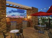 Outdoor Patio Grills and Tables With Red Umbrellas