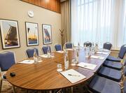 Boardroom table with chairs and water