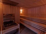 Wooden Sauna Interior With Bench Seating and Heater