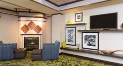 Hotel Lobby Seating Area with Armchairs, Footrests, Fireplace and HDTV
