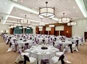 Place Settings and Flowers on Round Tables in Ballroom