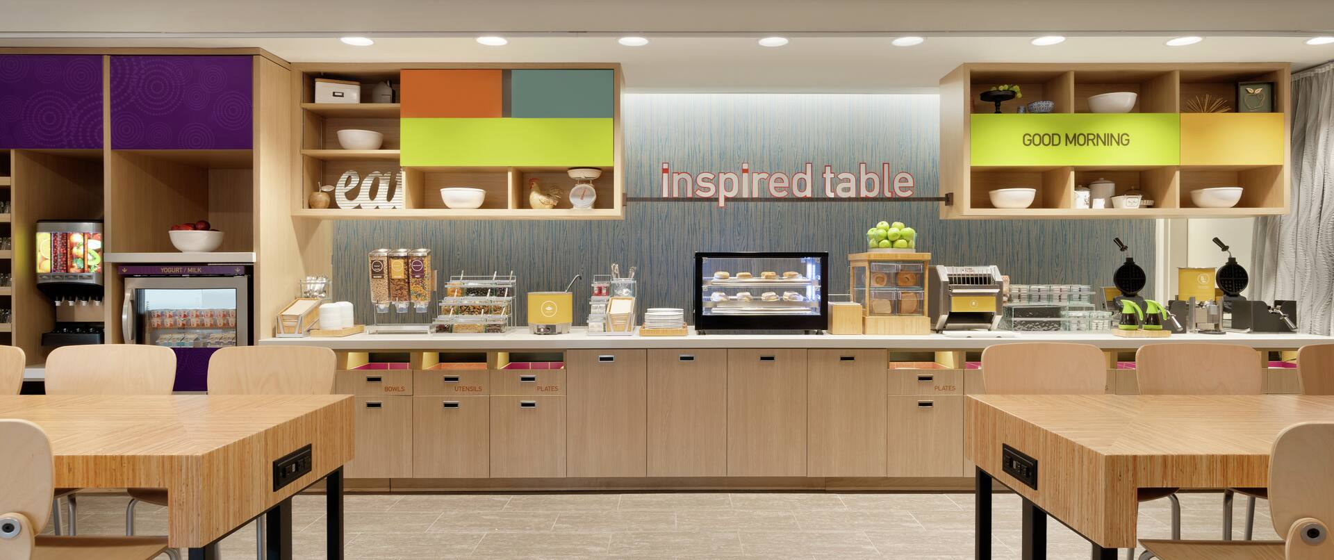 Bright breakfast area featuring family style seating and complimentary daily buffet.