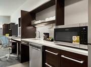 Accessible King Studio Suite Kitchen Area with Amenities, Work Desk and Television 
