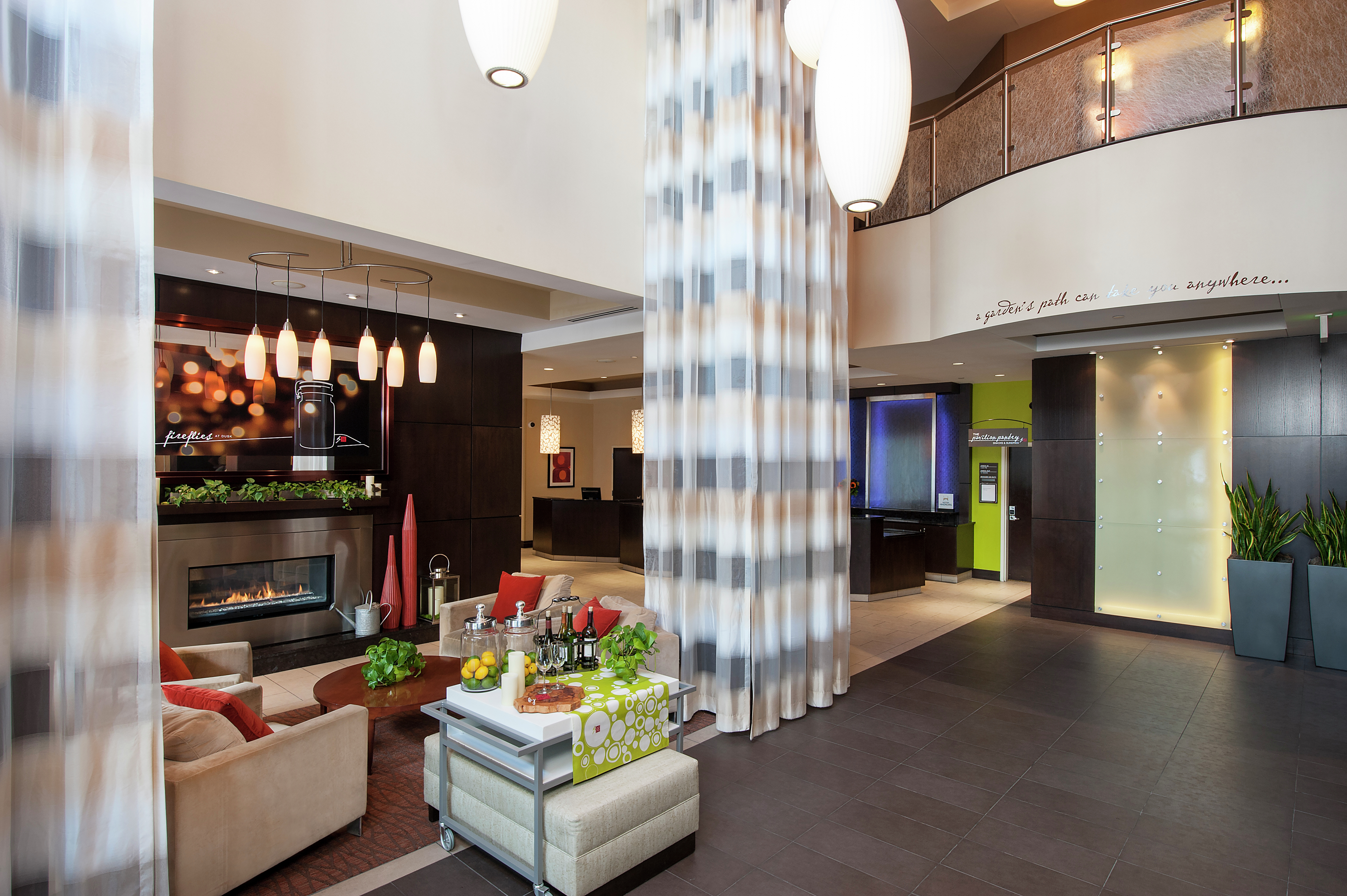 Soft Seating Around Fireplace and Beverage Center in Hotel Lobby 