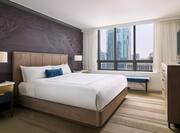 Suite Bedroom with Bed, Television and Outside City View