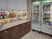 Snack Shelves and Refrigerator at 24-Hour Suite Shop