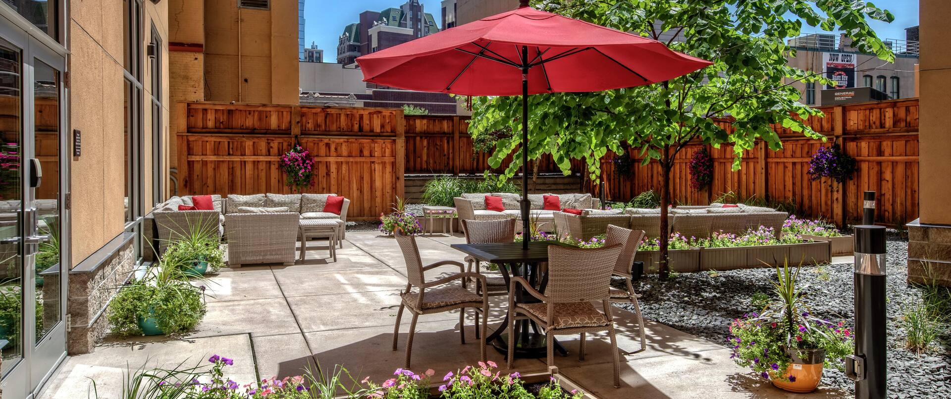 Outdoor Patio Area with Chairs, Tables and Umbrella at Daytime