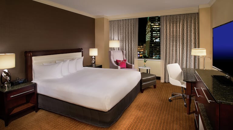 King-Sized Bed and City View at Night