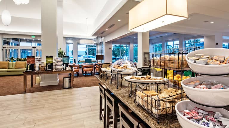 Buffet Selections on Counters of Breakfast Service Area of Garden Grille & Bar With View of Dining Tables by Windows