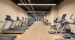 Long room with cardio fitness machines against both walls