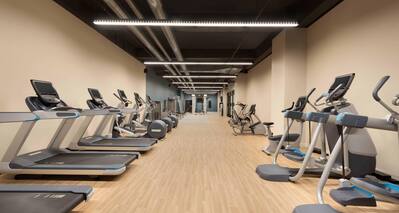 Long room with cardio fitness machines against both walls