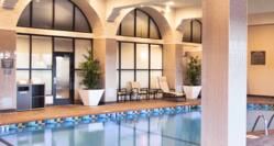 Indoor Pool Area with Columns and Arched Windows