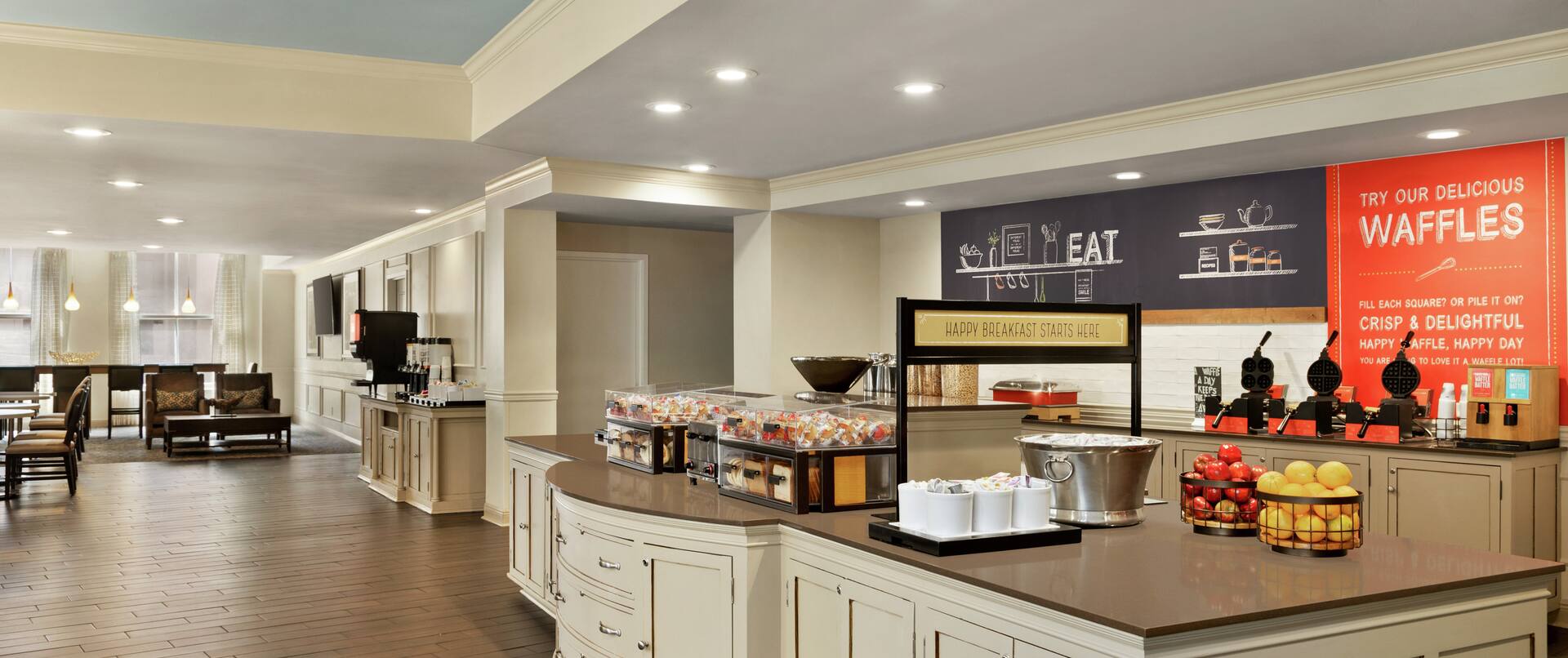 Bright breakfast area featuring a daily complimentary buffet overflowing with delicious food and beverages.