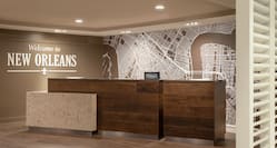 Welcoming hotel front desk featuring eye-catching mural and stylish design.