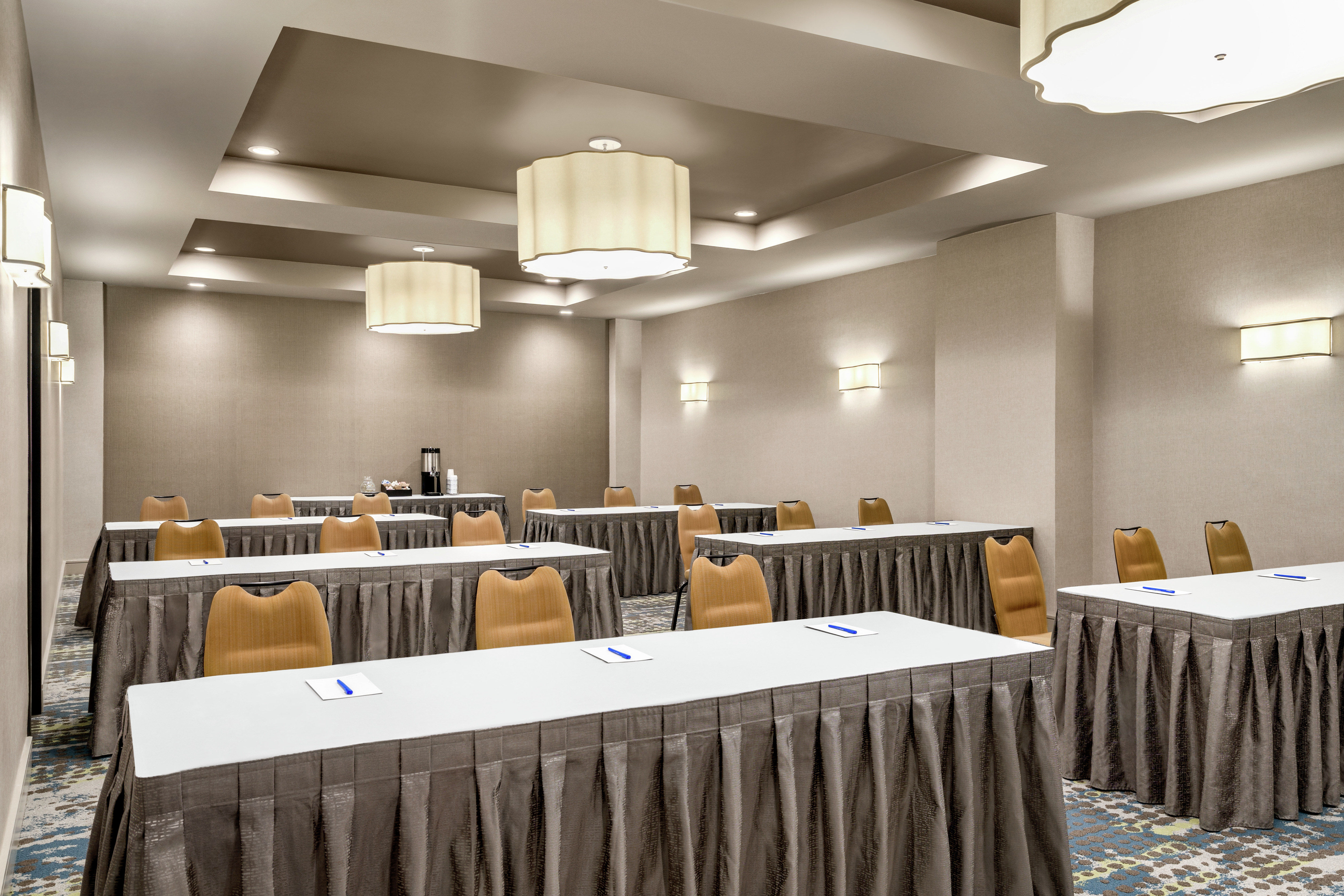 Spacious on-site meeting room featuring classroom style set up and refreshment table.