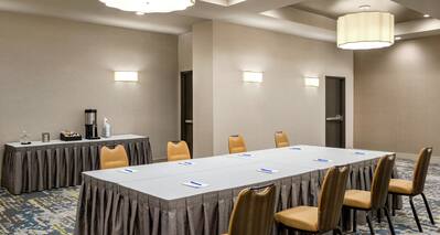 Spacious on-site meeting space featuring boardroom setup with ample seating and refreshment station.