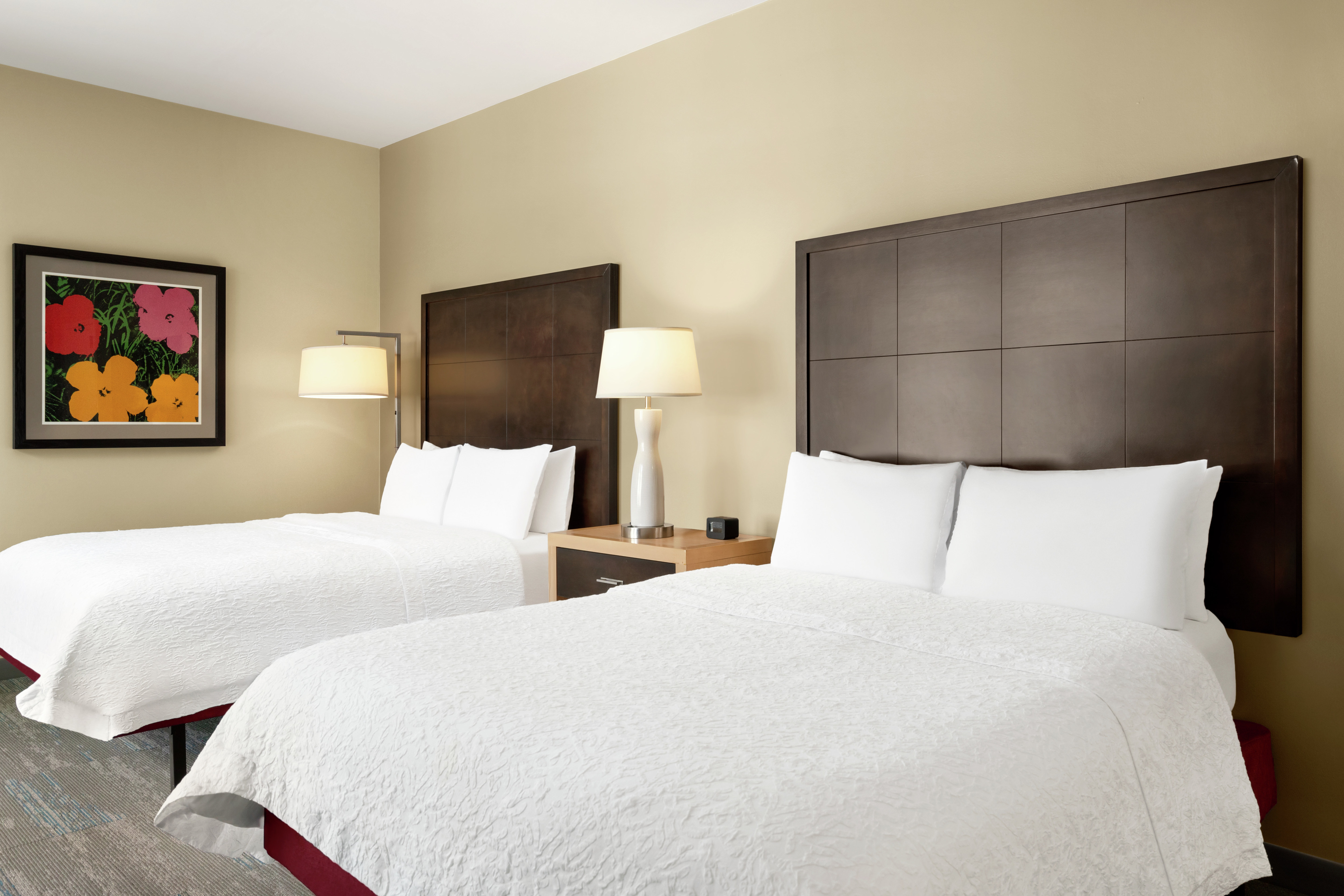 Bright accessible guest room featuring two comfortable queen beds.