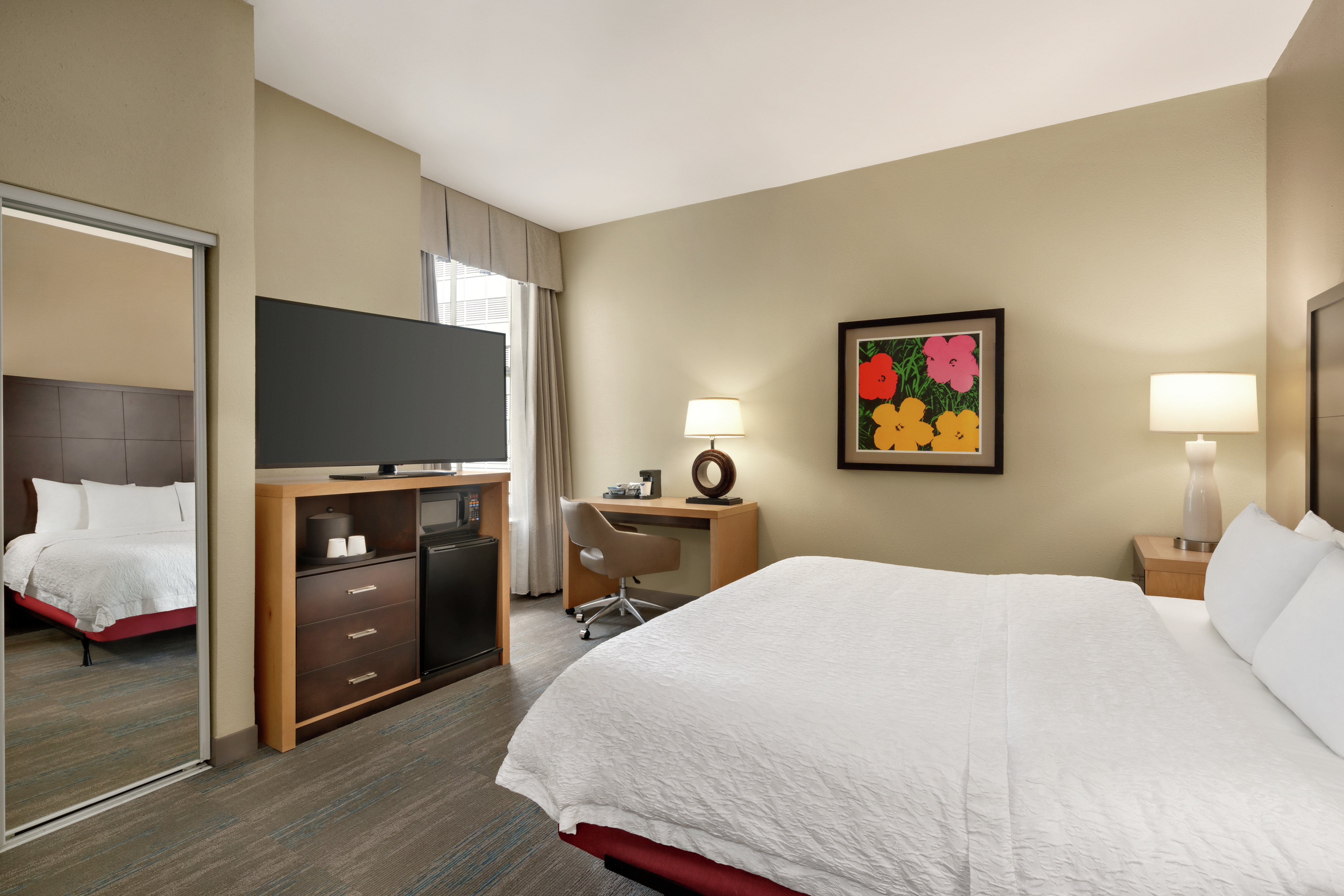 Spacious accessible guestroom featuring comfortable king bed, work desk, and TV.
