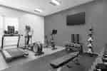 Spacious on-site fitness center fully equipped with cardio machines, spin bike, and free weights.