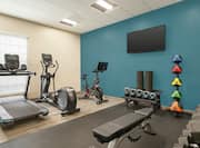 Spacious on-site fitness center fully equipped with cardio machines, spin bike, and free weights.