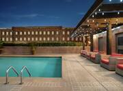 Rooftop Pool at Dusk with Lounge Seating on Deck
