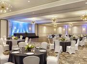Spacious on-site ballroom featuring stunning social banquet setup, dance floor, and head table.