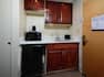 Entry by Wet Bar With Wood Cabinets, Mini Fridge, Microwave in Guest Room
