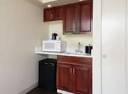 Wet Bar With Wood Cabinets, Mini Fridge, Microwave in Guest Room