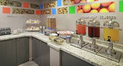 Breakfast Area with Food, Orange, and Cranberry Juice on Counter