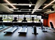 fitness center with treadmills and exercise bikes