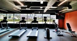 fitness center with treadmills and exercise bikes