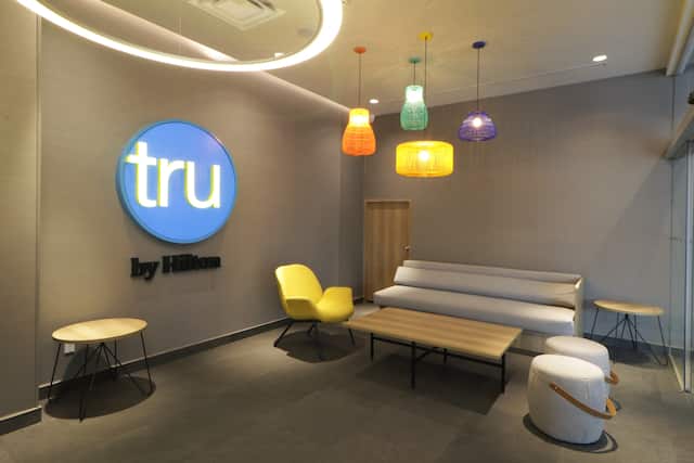 lobby seating area, Tru by Hilton sign