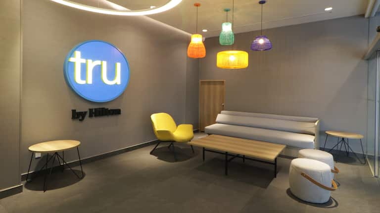 lobby seating area, Tru by Hilton sign
