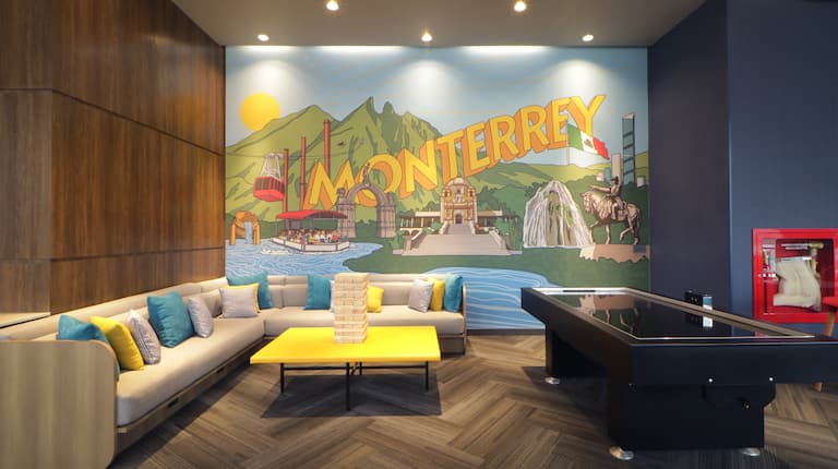 lobby seating area, air hockey table, Monterrey wall mural