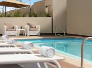 Outdoor pool with loungers and towels