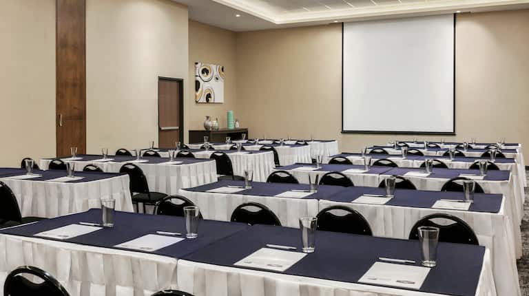 Meeting Room Classroom Setup with Chairs, Tables and Projector Screen