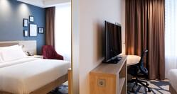 queen suite bedroom and TV with desk